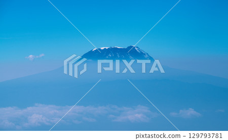 Aerial view of Mount Kilimanjaro floating in a sea of clouds 129793781