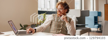 Dedicated and Focused Professional Engaged in Modern and Innovative Office Space Environment 129794103