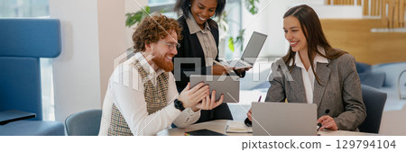 Dynamic Collaborative Team Meeting in a Modern Office Space for brainstorming and discussion Dynamic Collaborative Team Meeting in a Modern Office Space for brainstorming and discussion 129794104