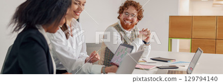 A Business Team Actively Collaborating in a Modern Office Environment for Optimal Outcomes 129794140