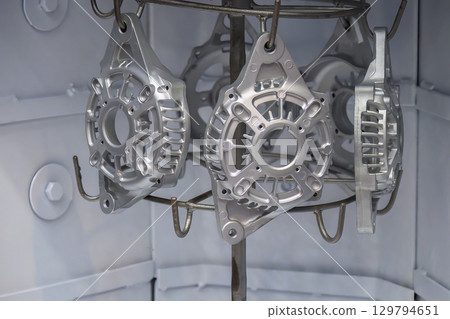 Close up scene cleaning and etching surface process the generator parts in sandblast machine. Close up scene cleaning and etching surface process the generator parts in sandblast machine. 129794651