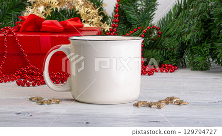 White mug standing on white wooden table with christmas decorations 129794727