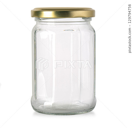 Empty glass jar with golden lid standing on white background 129794756