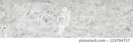 White concrete wall texture showing signs of age and wear 129794757