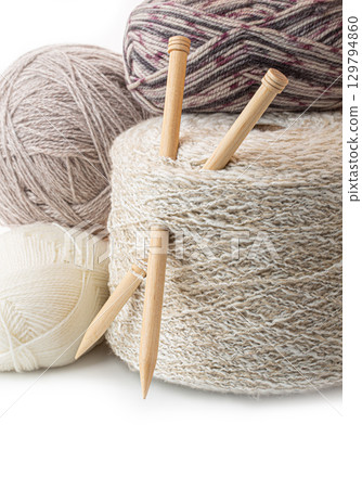 Knitting needles and skeins of yarn creating cozy crafts 129794860