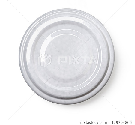 Grey metal lid from a jar resting on white background 129794866