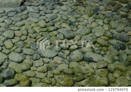 The pebble-covered grounds and clear stream of Kenrokuen Garden in Kanazawa, and the bottom of the Japanese garden. The pebble-covered grounds and clear stream of Kenrokuen Garden in Kanazawa, and the bottom of the Japanese garden. 129794978