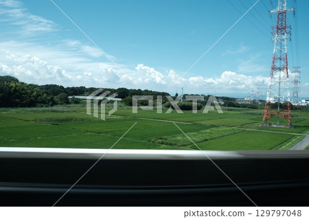 Rural scenery and blue sky seen from the Shinkansen Rural scenery and blue sky seen from the Shinkansen 129797048