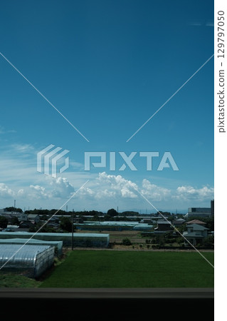 Summer blue sky and cumulonimbus clouds, rural landscape and view of agricultural areas. Summer blue sky and cumulonimbus clouds, rural landscape and view of agricultural areas. 129797050