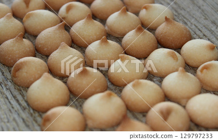 Miniature Round Biscuits Laid Out In Many Even Rows On A Wooden Board Stock Photo For Bakery Backgrounds 129797233
