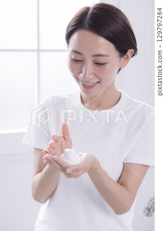 Beauty image: A woman washing her face Beauty image: A woman washing her face 129797264