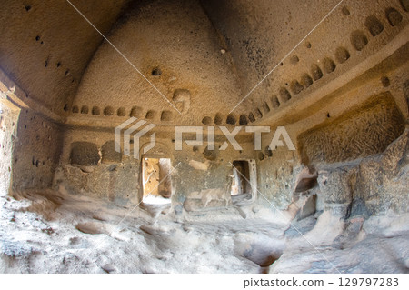 Unique cave dwelling in Turkey showcasing ancient architecture and natural formations 129797283
