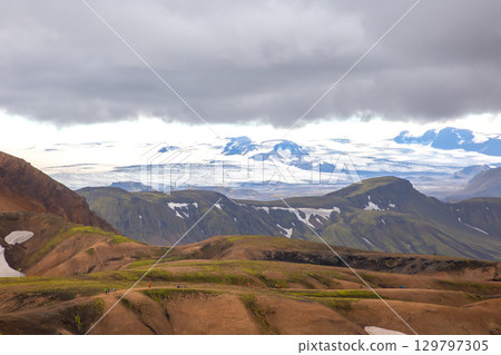 Exploring the rugged landscapes of Iceland with distant glaciers under dramatic clouds Exploring the rugged landscapes of Iceland with distant glaciers under dramatic clouds 129797305