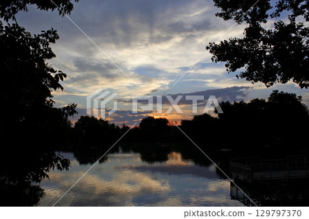 sunset over the pond sunset over the pond 129797370