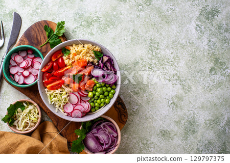 Balanced healthy bowl with vegetables and salmon 129797375