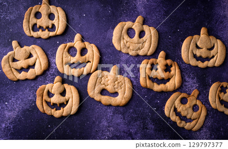 Halloween cookies in shape of jack-o-lantern 129797377
