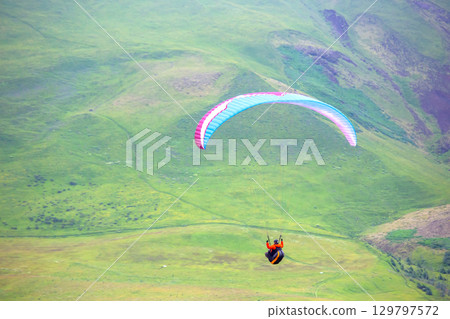Spectacular paragliding adventure over the lush landscapes of Iceland's hills 129797572