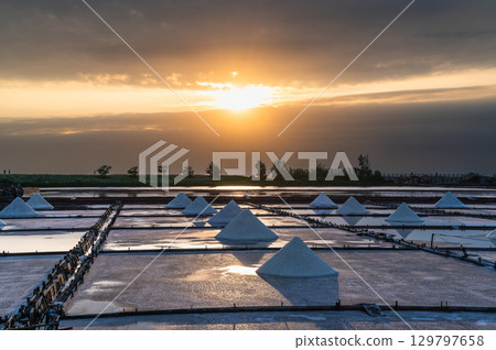 Sunset Over Qigu Salt Fields with Cloud-Covered Sun, Tainan City. 129797658