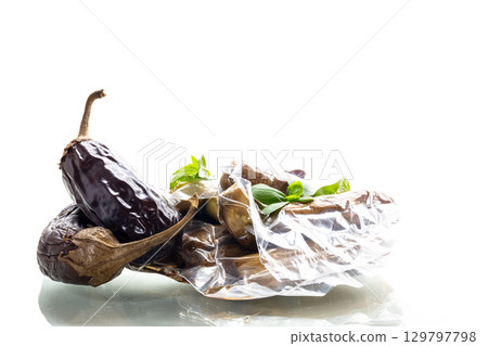 baked eggplants in a vacuum bag on a white background 129797798