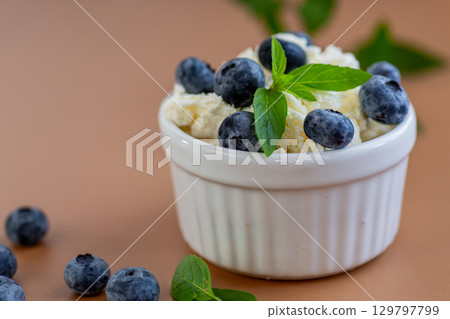 Healthy breakfast cottage cheese with blueberries and fresh mint 129797799