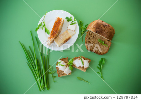 Sandwich with lard on rye bread and green onions on top Sandwich with lard on rye bread and green onions on top 129797814