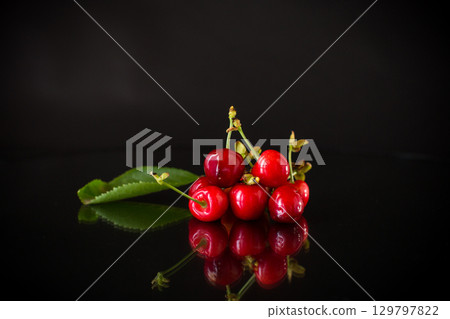 delicious red cherries on a black background 129797822