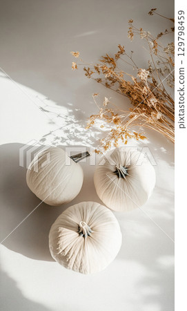 Craft a cozy autumn vibe with elegant white pumpkins and dried flowers 129798459