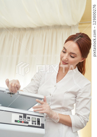 Female caucasian adult technician using laboratory equipment for scientific 129800276