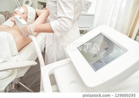 Laser hair removal session for young caucasian female in modern clinic Laser hair removal session for young caucasian female in modern clinic 129800295