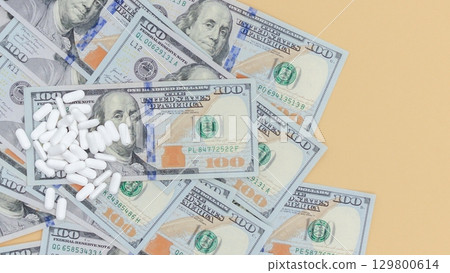 Medication Expenses Pills Scattered on U.S. Currency Representing Healthcare Costs Medication Expenses Pills Scattered on U.S. Currency Representing Healthcare Costs 129800614