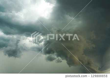 Dark storm clouds with dramatic sky formation before heavy rain and thunderstorm approaching 129800858