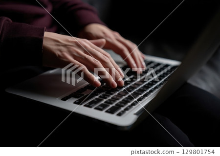 Programmer writing code on laptop keyboard in dark room Programmer writing code on laptop keyboard in dark room 129801754