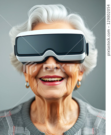 Grandmother Wearing Virtual Reality Headset, Joyful Embracing Technology and Innovation concept 129802054