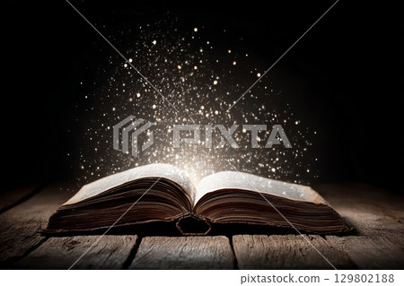 Open book with glowing sparkles. Perfect for magical art or fantasy designs, this enchanting scene inspires wonder. 129802188