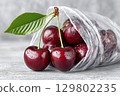 Fresh red cherries spilling from plastic bag on gray surface. Preparing for winter storage 129802235