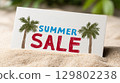 Summer sale sign with palm trees on a sandy beach 129802238