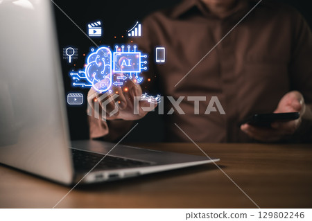 A businessman use futuristic AI power digital interface display artificial intelligence, machine learning, data analytics, automation, and media technology, symbol innovation and smart solutions. 129802246