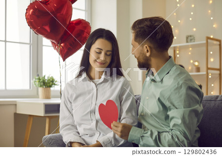 Young couple in love celebrating Valentine's Day and having a romantic date at home Young couple in love celebrating Valentine's Day and having a romantic date at home 129802436