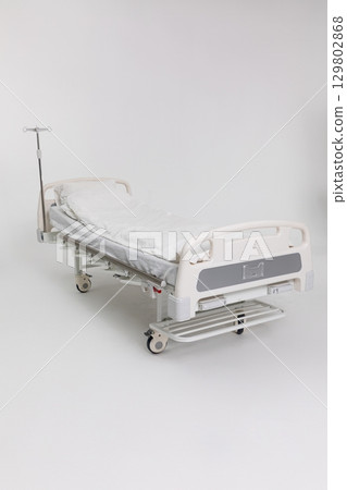 A Hospital Bed featuring an IV Stand designed for use in a Clinical Setting for patients 129802868