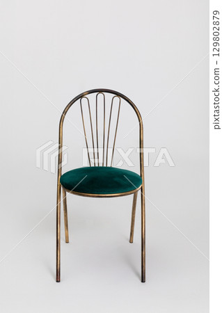 A Beautiful and Elegant Metallic Chair Featuring a Plush Green Velvet Cushion for Comfort A Beautiful and Elegant Metallic Chair Featuring a Plush Green Velvet Cushion for Comfort 129802879