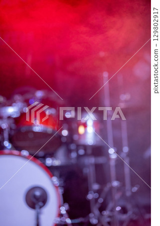 An incredibly vibrant drum set surrounded by a colorful and lively background display 129802917