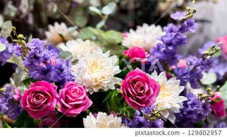 Vibrant floral arrangement with roses, chrysanthemums, and lavender in bloom 129802957