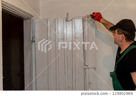 When painting an interior door, it is essential to do so with careful precision and attention 129802969