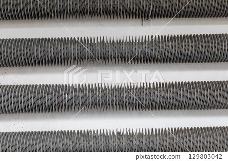 A closeup view showcasing various Industrial Metal Components meticulously arranged in rows A closeup view showcasing various Industrial Metal Components meticulously arranged in rows 129803042