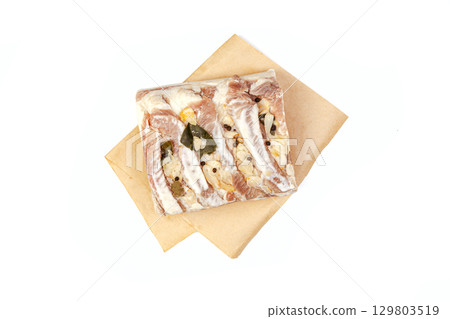 Lard or salo with bay leaf and black peas isolated on white background. Lard or salo with bay leaf and black peas isolated on white background. 129803519