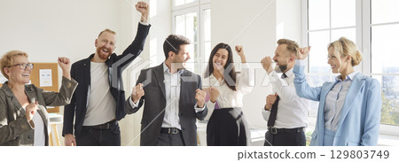 Team Of Happy Business People Celebrating Success Together In Office 129803749