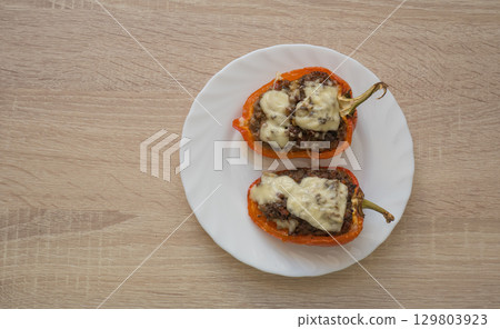 bell peppers stufed with meat, vegetables and cheese, top view. bell peppers stufed with meat, vegetables and cheese, top view. 129803923