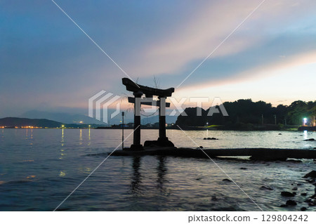 Sunset and torii gates in the sea Sunset and torii gates in the sea 129804242