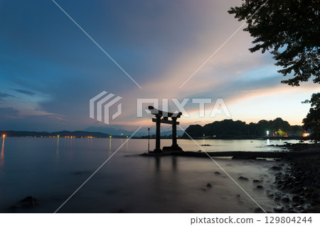 Sunset and torii gates in the sea Sunset and torii gates in the sea 129804244