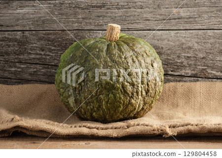 Fall Harvest Crespo Squash With Warty Skin on Burlap Fall Harvest Crespo Squash With Warty Skin on Burlap 129804458
